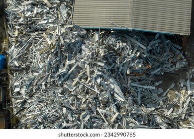 Aerial view of large pile of scrap aluminum metal from broken houses after hurricane Ian swept through Florida. Recycle of broken parts of mobile homes - Powered by Shutterstock