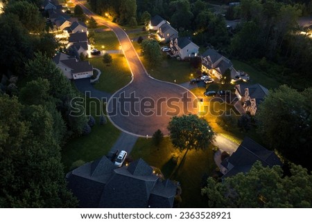 Aerial view of large private homes in Rochester, NY residential area at night. New family houses as example of real estate development in american suburbs