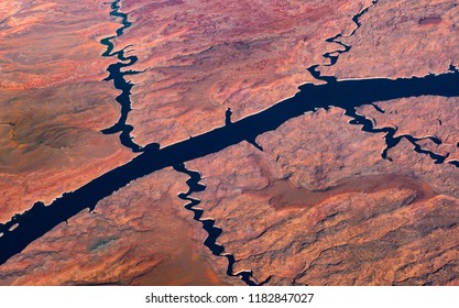 Aerial view of a large river and smaller tributary rivers flowing across a desertic land	 - Powered by Shutterstock