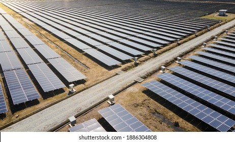 Aerial view of a large scale solar panel farm. It harvesting sun's power to create a flow of electricity. Reduce Reuse and Restore concept