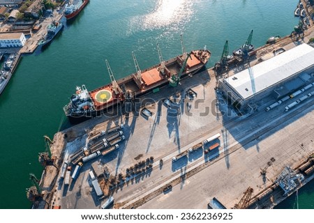Aerial view of a large ship loading grain for export. Water transport 
