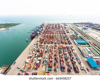 Aerial view of large shipping port with goods cargo containers, cranes and shipping vessels. Taken in afternoon on sunny day. - Shutterstock ID 663458257