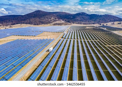 Aerial View Of A Large Solar Farm For Renewable Energy Supply In Canberra, Australia On A Countryside Mountain Landscape Background