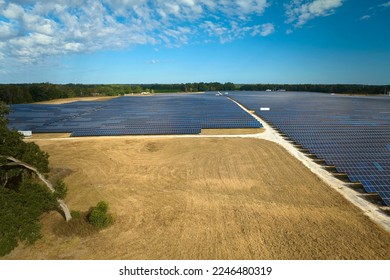 Aerial view of large sustainable electrical power plant with rows of solar photovoltaic panels for producing clean electric energy. Concept of renewable electricity with zero emission - Shutterstock ID 2246480319