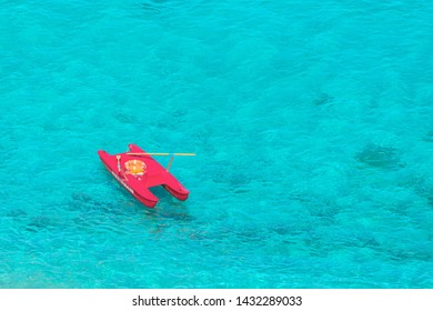 Aerial View Of Lifeguard Boat (salvataggio) In Beautiful Clear Tropical Sea Water In Italy – Baywatch Italian Rescue Boat With Oars And Life Preserver In Ocean – Minimalism Concept Of Adventure