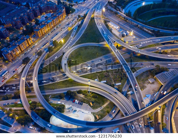 Aerial\
view of lighted highway road junctions at\
night