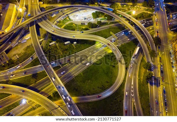 Aerial\
view of lighted highway road junctions at\
night