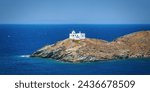 Aerial view of the lighthouse and Agios Nikolaos Church entering the port of Tzia, Kea island, Cyclades, Greece