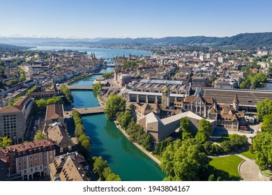 Aerial view of the Limmat river that flow through the Zurich city center by the national museum, the train station and the old town to finish in lake Zurich on a sunny summer day