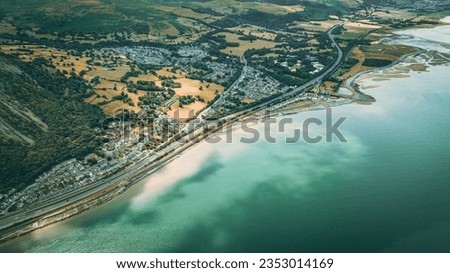 Aerial view of a little town surrounded by beautiful nature Llanfairfechan, North Wales, Cymru, UK