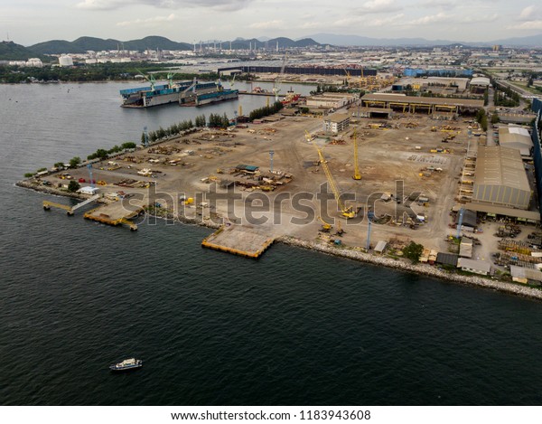 Aerial view of logistics concept commercial\
vehicles, cars and pickup trucks waiting to be load on to a\
roll-on/roll-off car carrier ship at Laem Chabang dockyard in\
Chonburi Province,\
Thailand