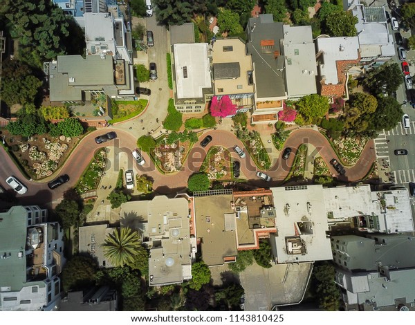 Aerial view Lombard Street, an east–west street in\
San Francisco, California that is famous for a steep, one-block\
section with eight hairpin turns. Crookedest, steep hills, sharp\
curves, one-way road