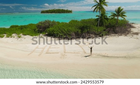 Aerial view lonely tropical inhabited island surrounded turquoise coral reef. Woman need rescue. Word HELP written on sand beach. Young female in bikini waving hands ask to save her. Drone flight