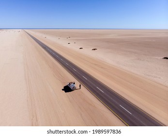 Aerial view of long and never ending street in Namibia. Drone photograph of straight road between sand. African landscape photography. - Powered by Shutterstock