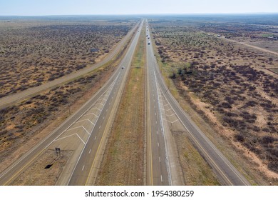 Aerial View Of Long Road Through Desert Landscape Towards Near San Jon New Mexico USA