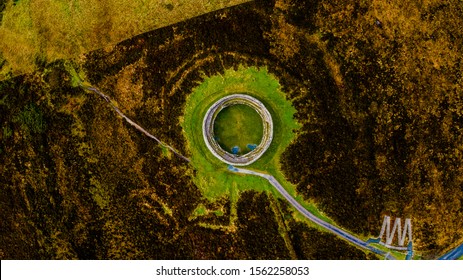 Aerial view looking down on donegal ring fort in ireland. Grainan of Aileach on a winters day with dry dark brown fields.