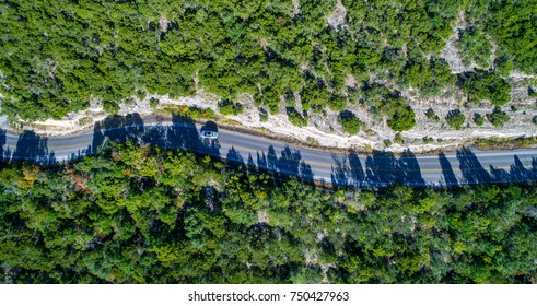 Aerial View Looking Down On Curvy Winding Rural Country Road Along Mount Bonnell Huge Limestone Cliffs In The Texas Hill Country Traveling Destination Road Trip