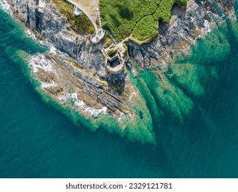 An aerial view looking down at the rocky coast of Pendennis Point near Falmouth, Cornwall, UK - Powered by Shutterstock