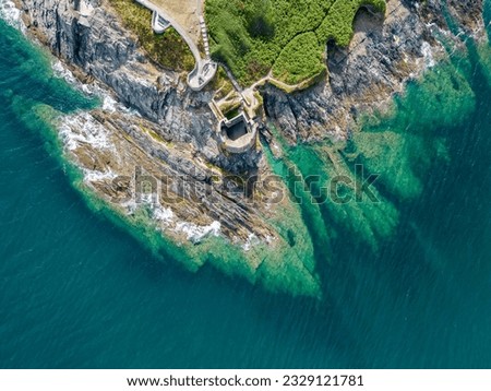 An aerial view looking down at the rocky coast of Pendennis Point near Falmouth, Cornwall, UK