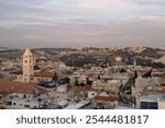 Aerial view looking east over the Old City of Jerusalem with the Redeemer Lutheran Church,  golden Dome of the Rock Islamic shrine,  and Mount Scopus in the distance. 