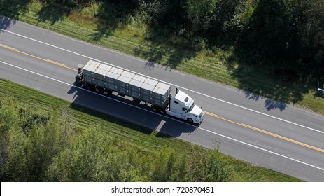 Aerial View Looking At The Large Transport Truck Hauling Cargo On The Highway In Central Quebec, Canada