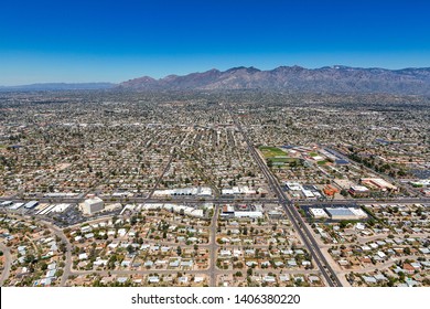 Aerial view looking north from above the intersection of Broadway & Swan in Tucson, Arizona with the Santa Catalina Mountains on the horizon