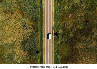 Aerial View Of Lorry Truck On The Road Through Countryside In Sunny Summer Afternoon