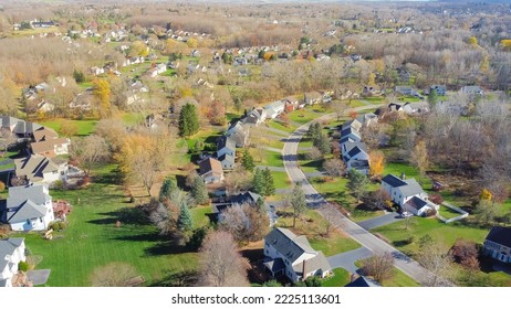 Aerial view low-density two story residential house in sprawl development outward expansion suburbs of Rochester, New York. Upscale suburban home with large lot size, green grassy lawn, fall season