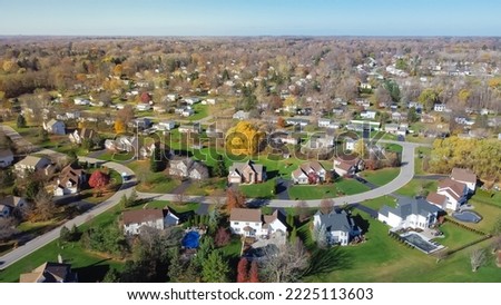 Aerial view low-density two story residential house in sprawl development outward expansion suburbs of Rochester, New York. Upscale suburban home with large lot size, green grassy lawn, fall season