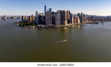 An Aerial View Of Lower Manhattan, NY On A Sunny Day With No Clouds. The East River Is Calm.