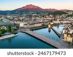 Aerial view of Lucerne city with Lake Lucerne, Chapel bridge and Mount Pilatus in sunrise light, Switzerland