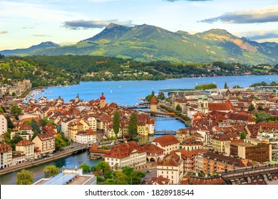 Aerial view of Lucerne skyline and lake Lucerne with Mount Rigi and its peak Rigi-Kulm in the Canton of Lucerne, Switzerland. Amazing panorama with sunset orange clouds and green hills.