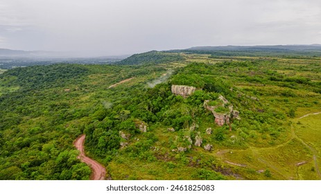 Aerial view of lush, green landscape with unique rock formations at Ciudad de Piedra, San Jose del Guaviare, Colombia - Powered by Shutterstock