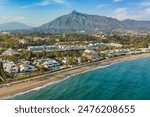 Aerial view of the luxurious Marbella resort town, Costa del Sol, Andalusia, Spain. Popular luxury and exclusive area of Marbella, Golden Mile beach. Top view of the expensive villas and hotels