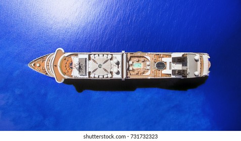 Aerial View Of Luxury Cruise Ship At Blue Ocean, Top Down View Of Swimming Pool And Deck