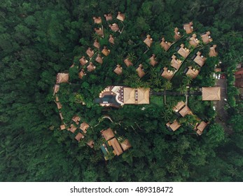 Aerial View Of Luxury Resort In Rain Forest Surrounded By Trees. Hotel With Cottages And Swimming Pool.