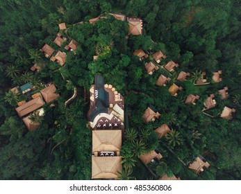 Aerial View Of Luxury Resort In Tropical Rain Forest Surrounded By Greenery.