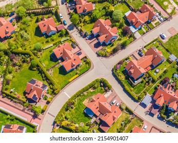 Aerial view of luxury upscale residential neighborhood gated community street real estate with single family homes brick facade colorful