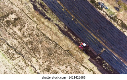 Aerial View Machinery Harvesting Peat Bog  In Rural Ireland