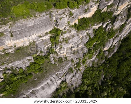 Similar – Image, Stock Photo Aerial view of intricate patterns created by natural erosion in the desert landscape of Utah, showcasing a network of ridges and grooves with varying shades of brown and gray