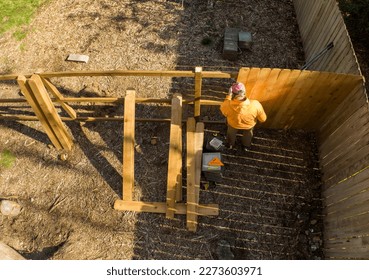 Aerial View of Man Building a Fence