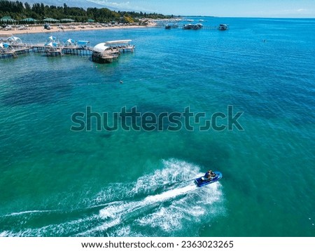 Aerial view of man riding personal watercraft in the lake