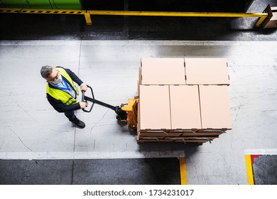 Aerial view of man worker with protective mask working in industrial factory or warehouse. - Powered by Shutterstock