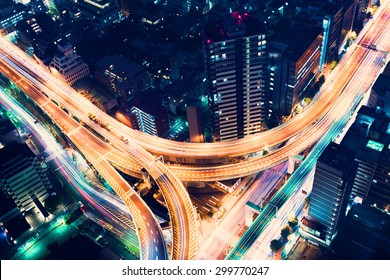Aerial view of a massive highway intersection at night in Shinjuku, Tokyo, Japan