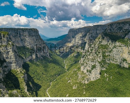 Aerial view of the massive limestone cliffs and deep canyon floor of the Vikos Gorge in the Zagori region, Greece