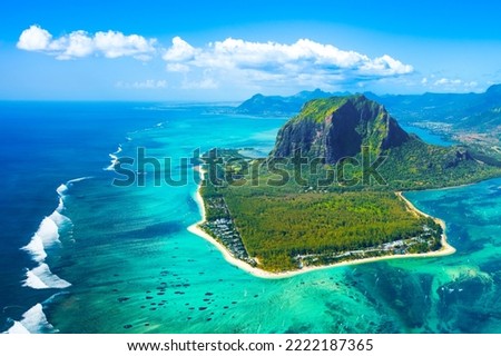 Aerial view of Mauritius island and Le Morne Brabant mountain with beautiful blue lagoon and underwater waterfall illusion 