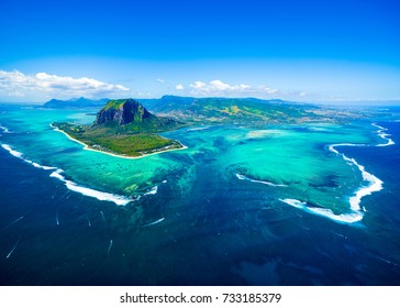 Aerial view of Mauritius island panorama and famous  Le Morne Brabant mountain, beautiful blue lagoon and underwater waterfall - Shutterstock ID 733185379