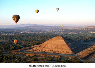 Aerial view at Maya Pyramid of the Sun and Moon at Teotihuacan, Mexico at sunrise with hot air balloons above - Powered by Shutterstock