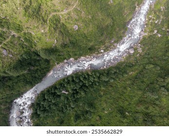 Aerial view of meandering river cutting through a lush green landscape - Powered by Shutterstock