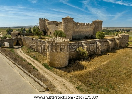 Aerial view of medieval Almenar castle near Soria Spain, four round towers protect the inner courtyard, surrounded by fortified outer walls
